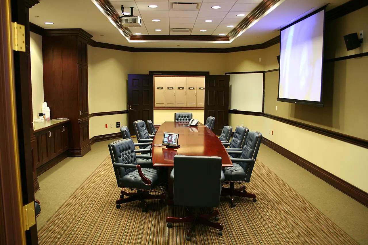 Video conference room with a projection screen and meeting table