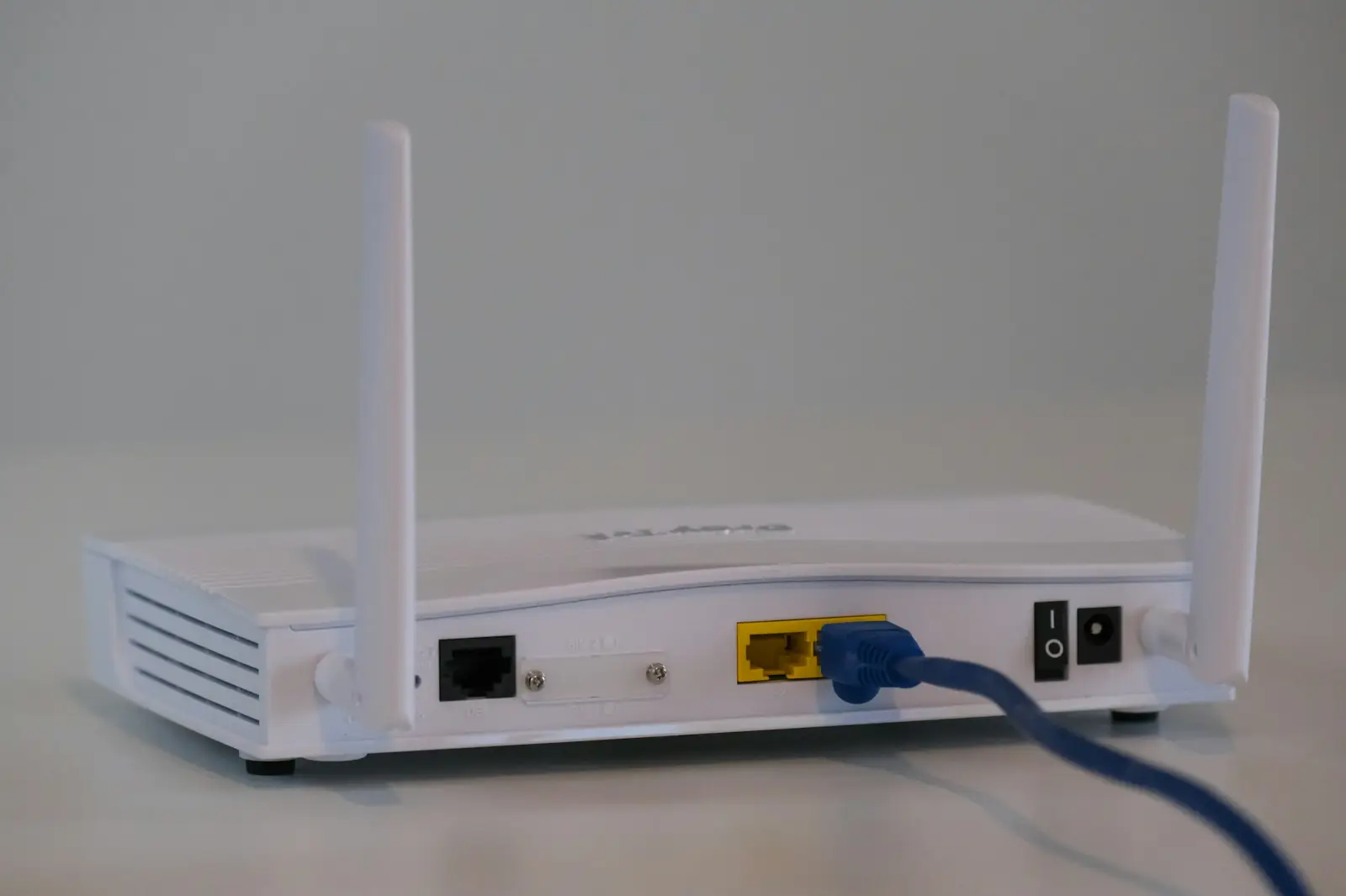 Wireless router with antennas and a connected network cable